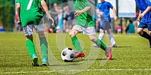 Children Soccer Players Running with the Ball. Kids in Blue and