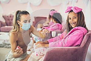 Children in spa center having a manicure.