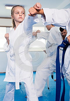 Children sparring in pairs in karate class