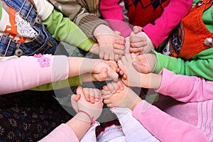 Children stand having joined hands, top view