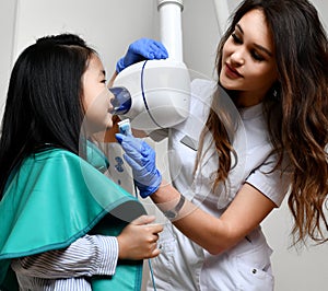 Children stomatologist makes dental procedure  x-ray machine. Panoramic radiography for asian kid girl with dentist equipment