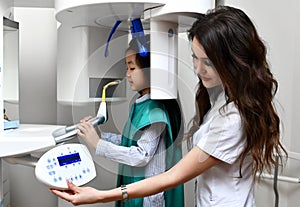 Children stomatologist makes dental procedure  x-ray machine. Panoramic radiography for asian kid girl with dentist equipment
