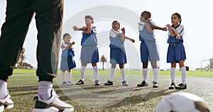 Children, stretching and sport on soccer field with coach for training and school fitness. Youth, kids and workout for