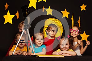 Children studying astronomy with telescope