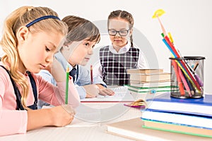 Children studying together and writing