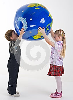 Children supporting the globe