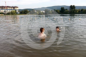 Children swim in lake