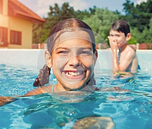 Children swim outdoors.