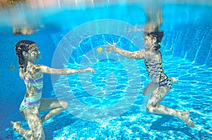 Children swim in pool underwater, happy active girls have fun under water