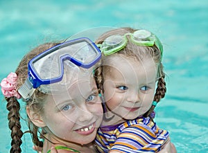 Children swim in swimming pool.