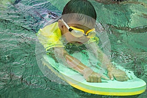 Children swimming. Boy Practice Swimming. Activities on the pool