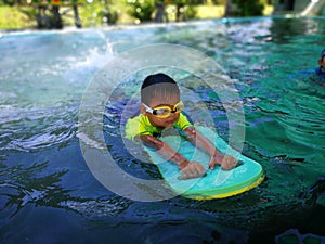 Children swimming. Boy Practice Swimming. Activities on the pool