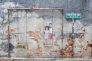 Children on the swing painted by Louis Gan at Chulia street in Georgetown, Penang