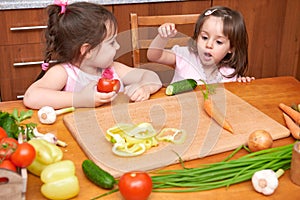 Children at the table with with fresh fruits and vegetables, home kitchen interior, healthy food concept