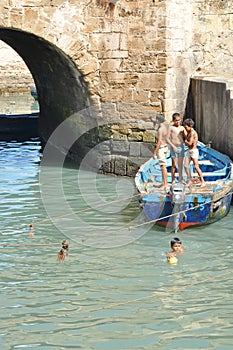 Children take a bath in the canal