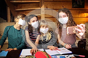 Children takes pictures wearing masks locked in their homes by a coronavirus pandemic