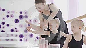 Children and teacher at the ballet school. Lesson of classical ballet in a dance school.