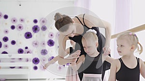 Children and teacher at the ballet school. Lesson of classical ballet in a dance school.