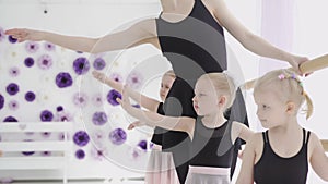 Children and teacher at the ballet school. Lesson of classical ballet in a dance school.