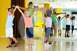 Children with teacher dancing in circle