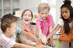 Children and teacher enjoying their friendly team