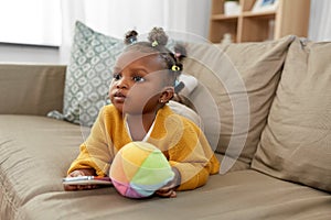 African american baby girl with smartphone at home