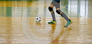 Children teen training soccer futsal indoor gym. Young boy with soccer ball training indoor football.