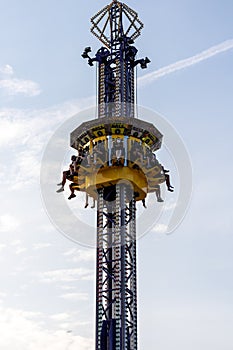 Children and teens' legs hanging from fair ride in air