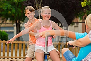 Children are teetering on the swing photo