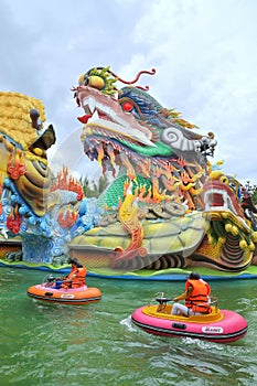 Children and their families are playing water games in the lake of Dam Sen in Saigon