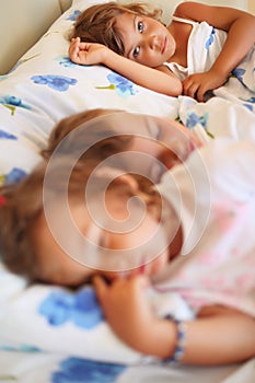Children three together sleeping on bed