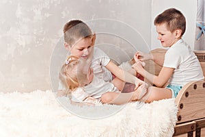 Children tickle bare feet