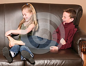 Children tickling feet