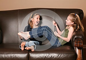 Children tickling feet