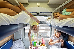 Children are tired of riding in a reserved seat train car without air conditioning for a long time