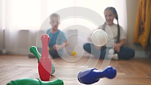 Children toddler a playing toy bowling on the floor. Happy family kindergarten kids dream concept. Children toddler play