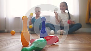 children toddler a playing toy bowling on the floor. happy family kindergarten kids dream concept. children toddler play