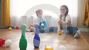 children toddler a playing toy bowling on the floor. happy family kindergarten kids dream concept. children toddler play