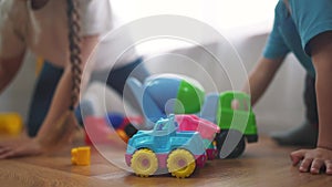 children toddler a playing toy car on the floor. happy family kindergarten kid dream concept. children toddler play toys