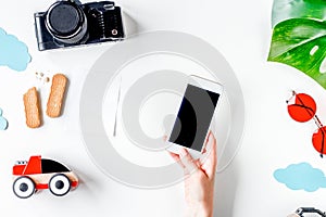 Children tourism outfit with camera and mobile on white background flat lay mockup