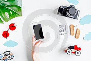 Children tourism outfit with camera and mobile on white background flat lay mockup