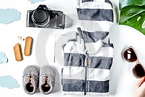 children tourism outfit with clothes and camera on white backgro