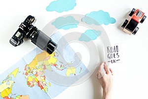 Children tourism outfit with map and camera on white background flat lay mockup