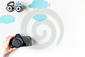 Children tourism outfit with toys and camera on white background