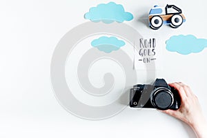 Children tourism outfit with toys and camera on white background flat lay mockup