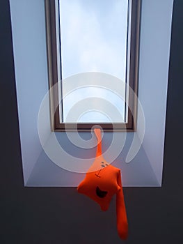Children toy with a noose around the neck hangs on the window