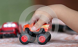 Children toy red car in the child's hand