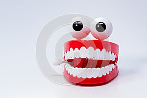 Children toy in shape of red gums, teeth with eyes attached