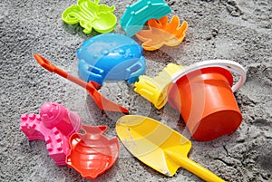 Children toys: bucker, shovel, sand molds lie on the sand. Children's beach sand toys.
