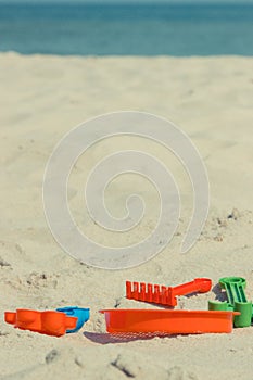 Children toys using for playing on sand at beach. Vacation and relaxation time. Copy space for text